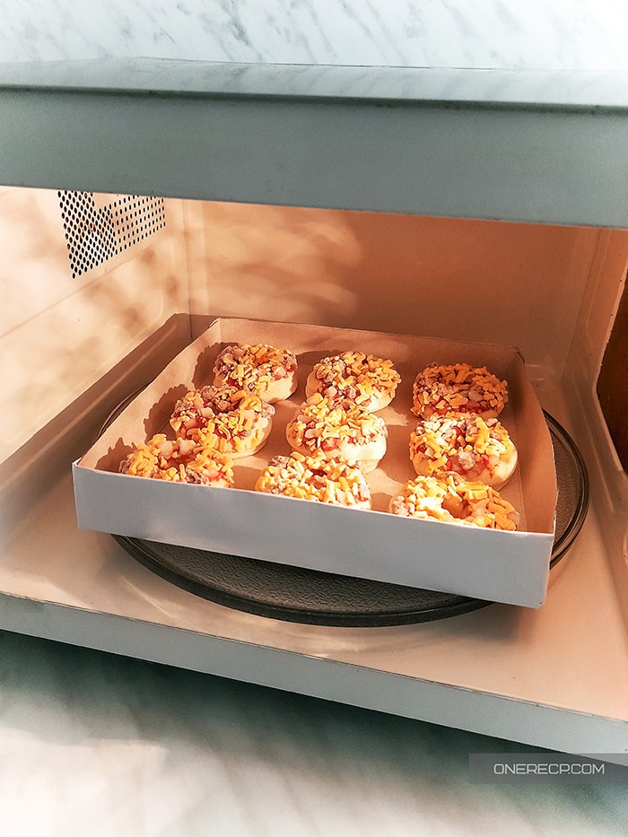 A tray of Bagel Bites in the microwave