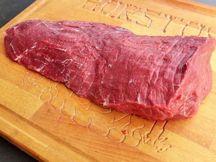 bottom round beef cut sitting on а cutting board