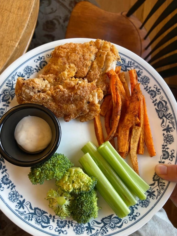 a plate containing keto fried chicken breaded with gluten free flour and some vegetables