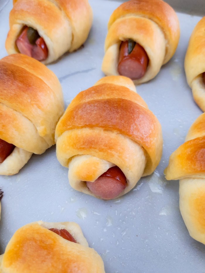 A close up of freshly baked crescent pigs in a blanket.