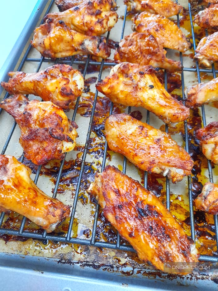 Oven baked chicken wings on a wire rack