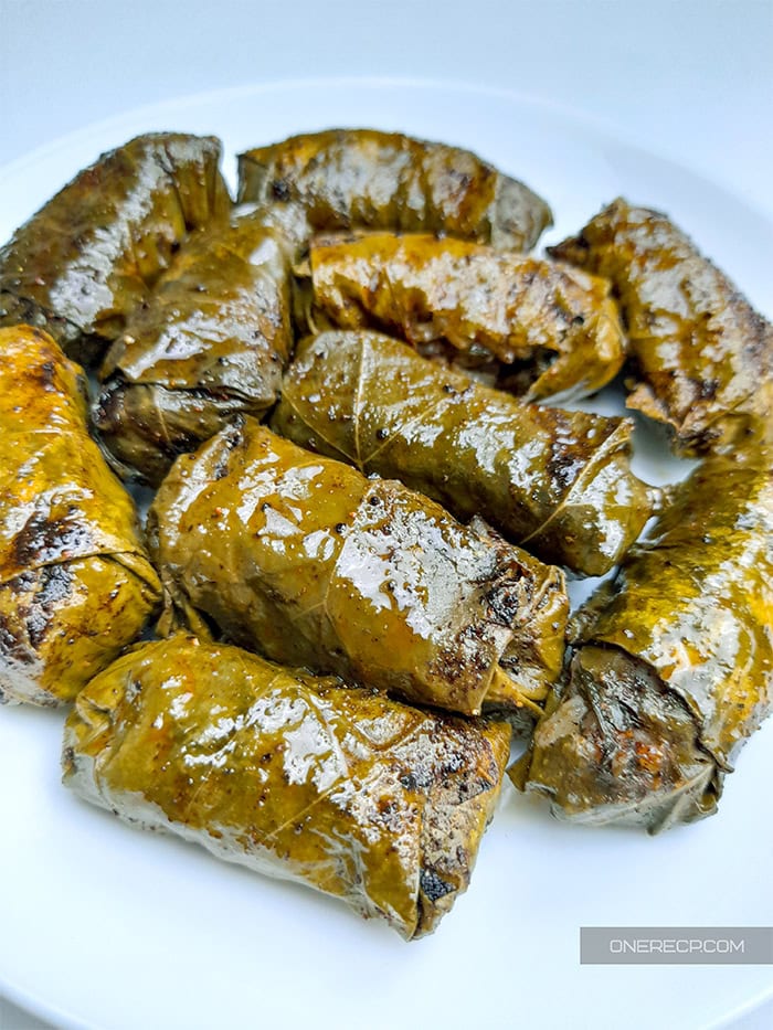 Close-up of a serving of Greek stuffed grape leaves