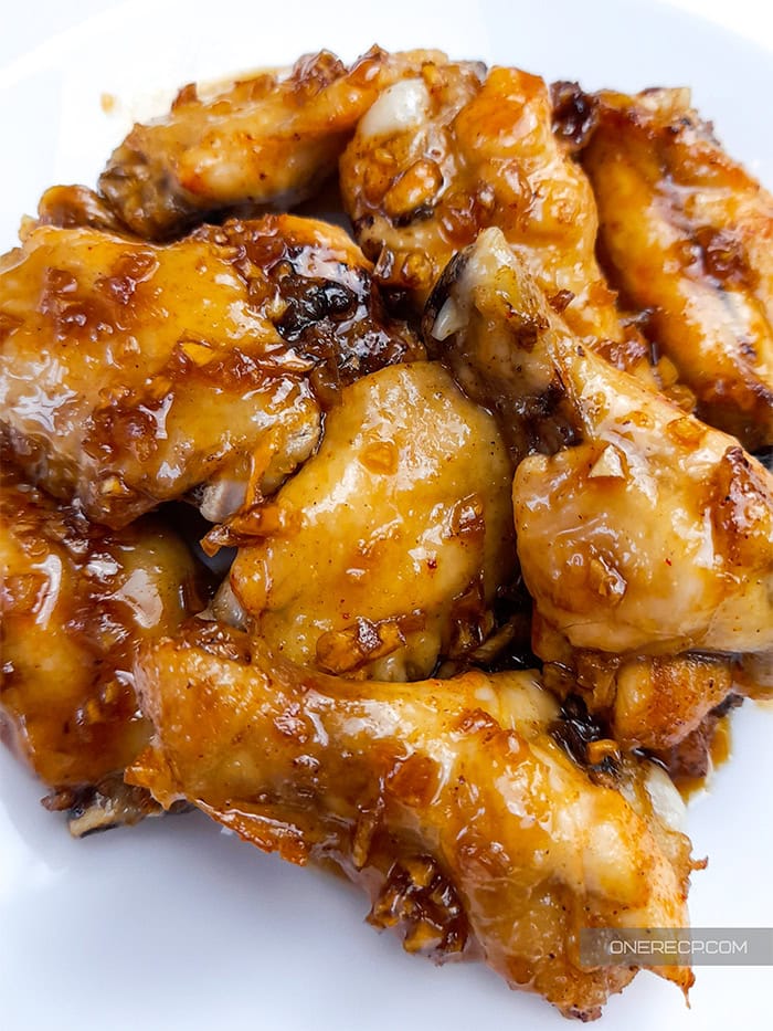 A serving of chicken wings with honey garlic sauce