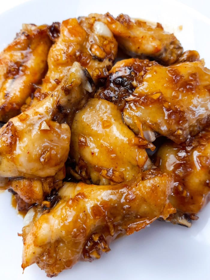 a serving of buffalo chicken wings covered in honey garlic sauce