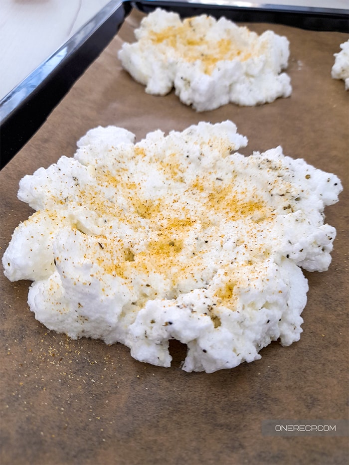 A nest of puffy egg white mixture made by denting it with a tablespoon