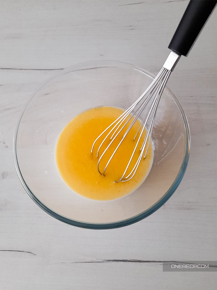 whisking the melted butter in a glass bowl