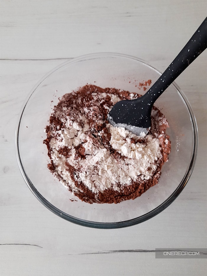 carefully stirring the brownie batter with a spatula