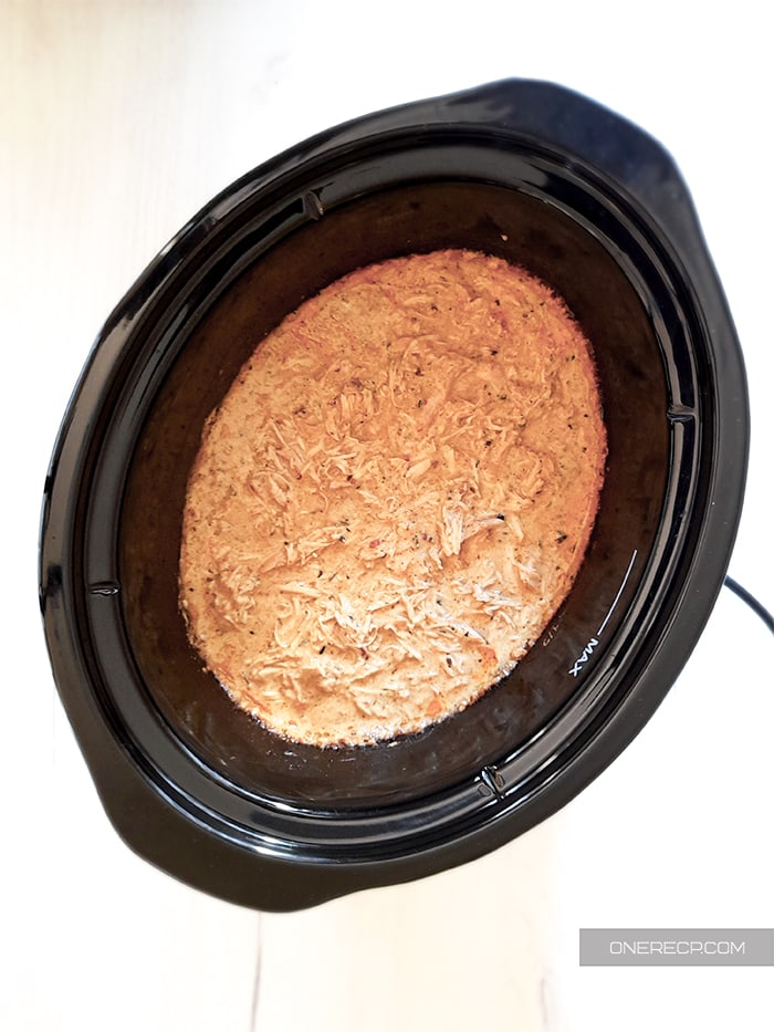 Cooked and shredded chicken breast in a Crockpot