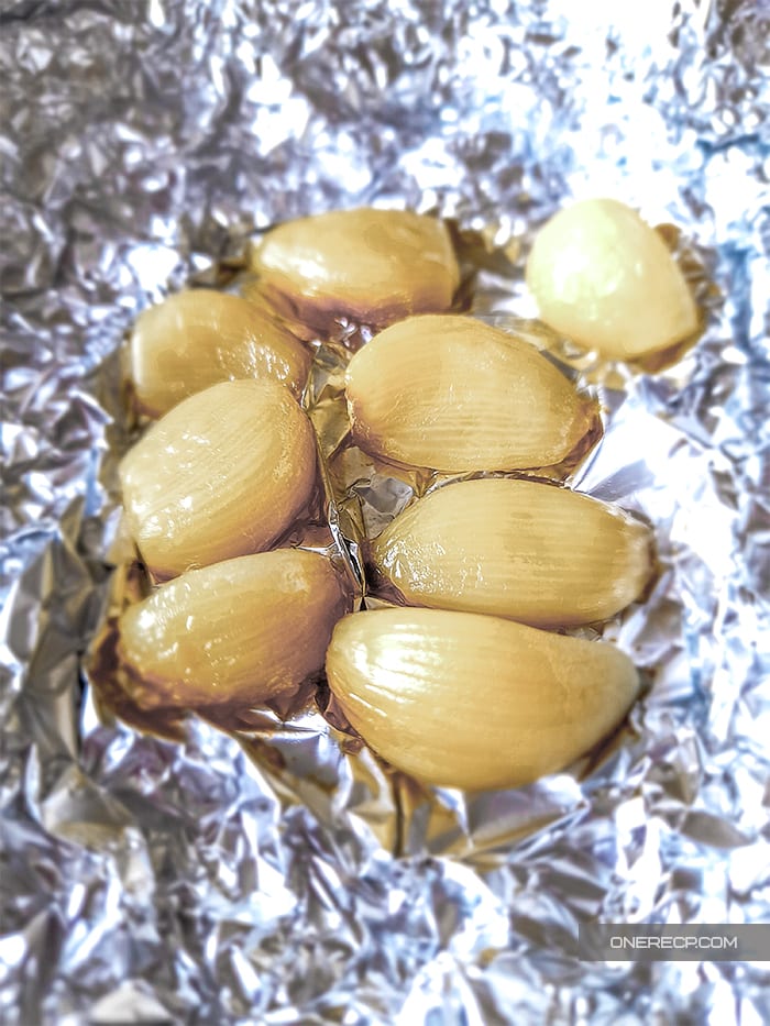 Roasted cloves of garlic in aluminum foil