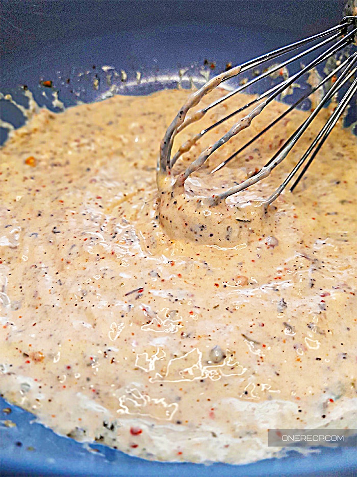 Whisked buffalo wild wings garlic parmesan sauce in a cooking bowl
