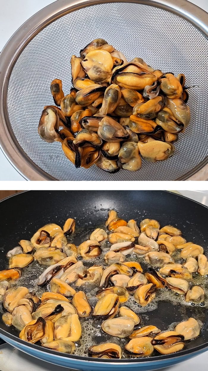 Cooked mussels drained in a colander and then pan fried in butter and oil