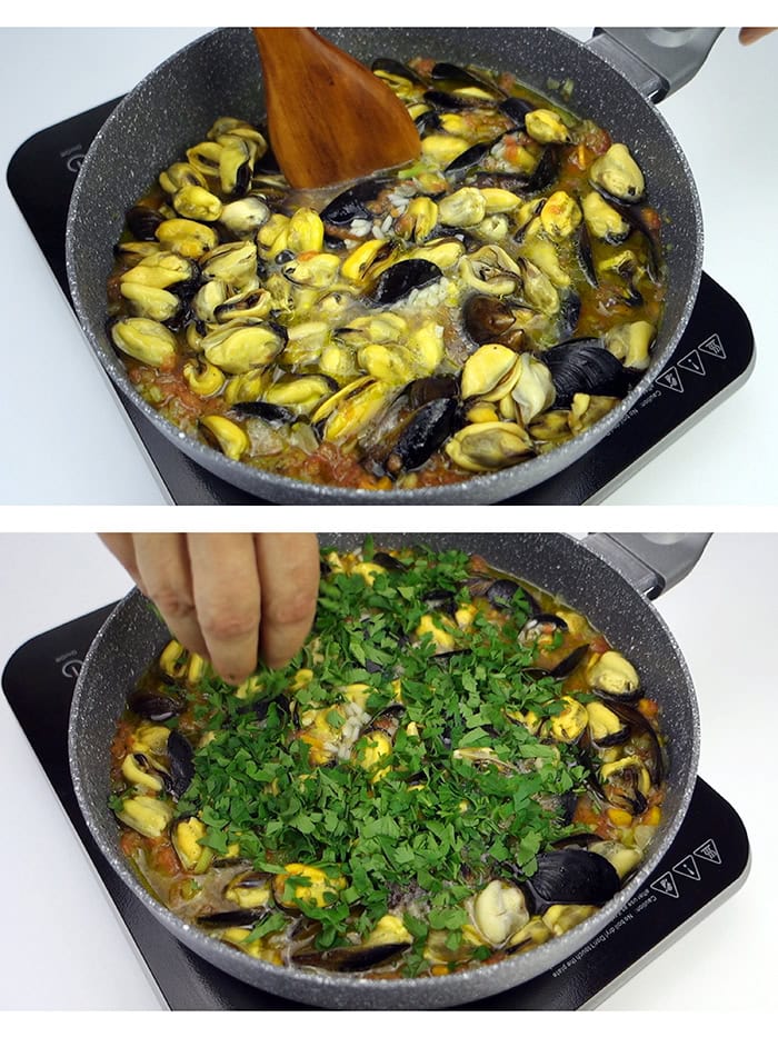Stirring the mussels with a wooden spoon and seasoning them with fresh parsley.