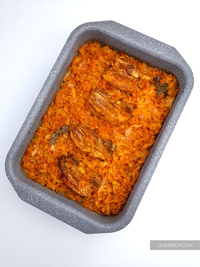 Baking dish with fully cooked pork and sauerkraut