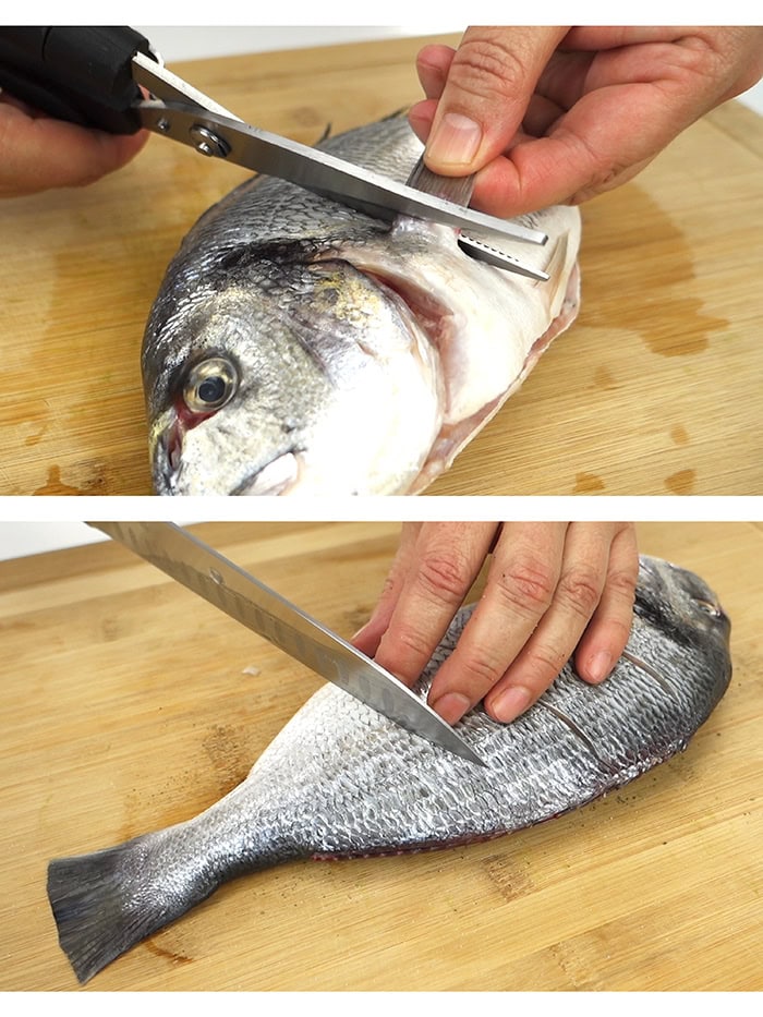 Trimming the fins off sea bream and scoring it with a knife
