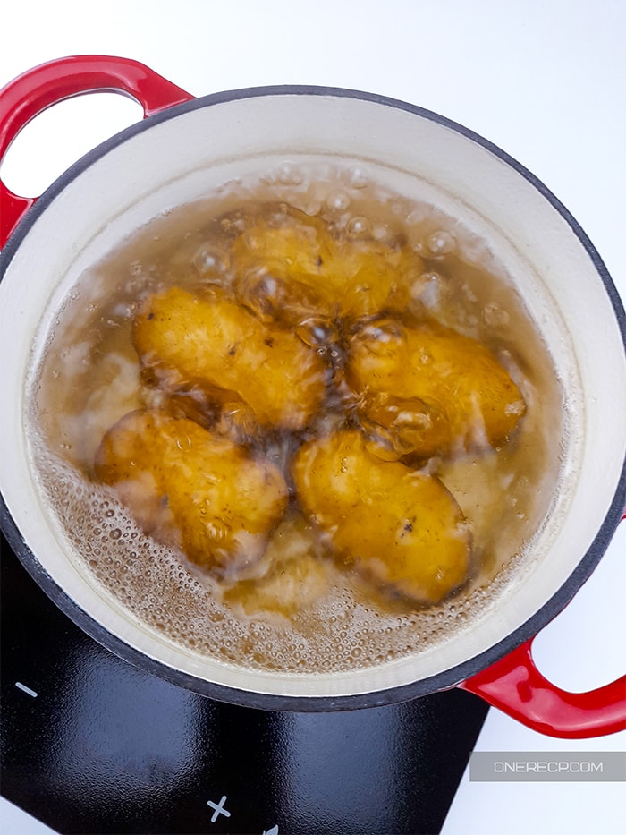 Potatoes being boiled in a pot of water