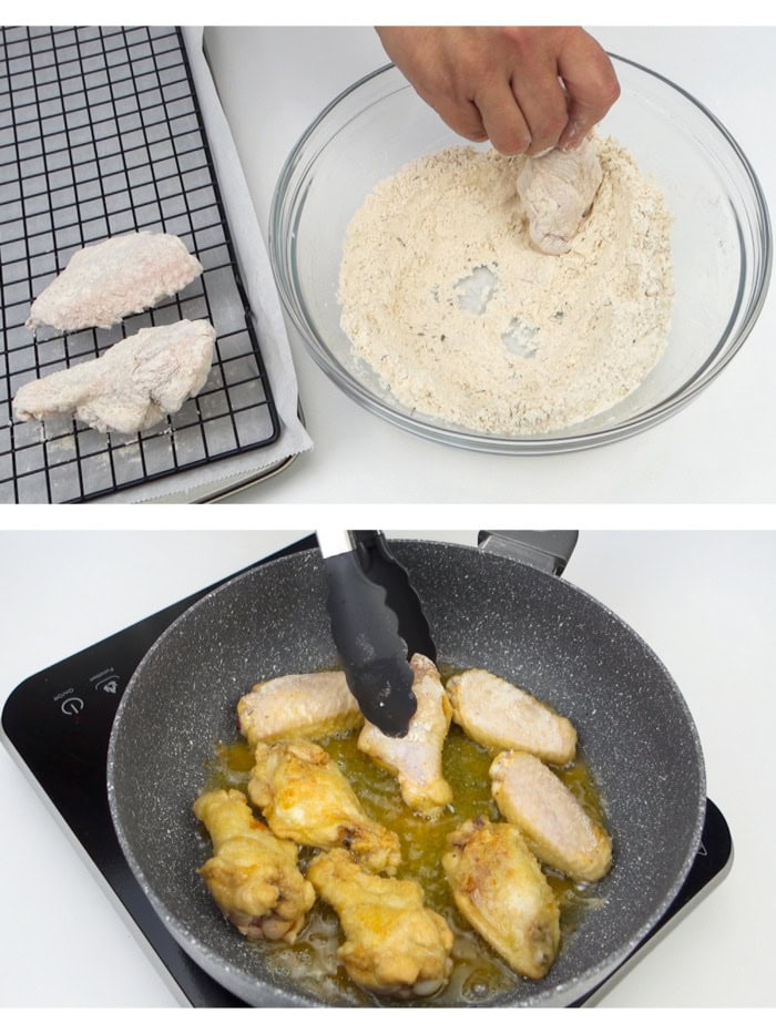 Dredging the chicken wings in flour and frying them in vegetable oil