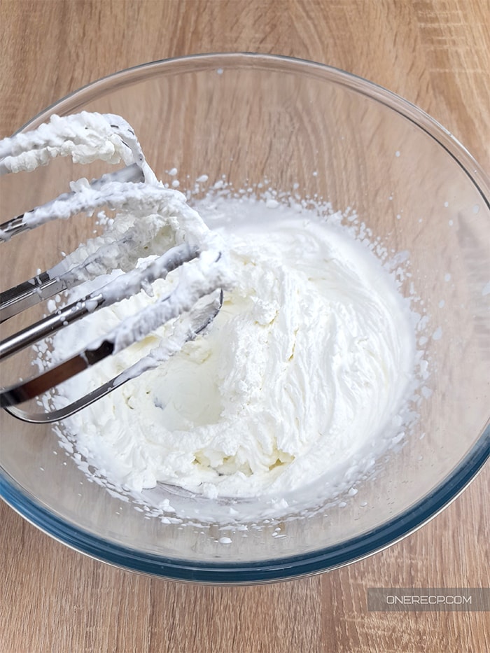 a glass bowl with whipped fluffy heavy cream