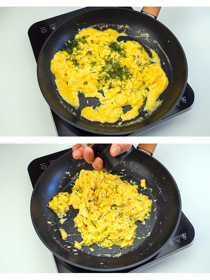 A pan with partially cooked scrambled eggs next to a pan with fully cooked scrambled eggs seasoned with pepper