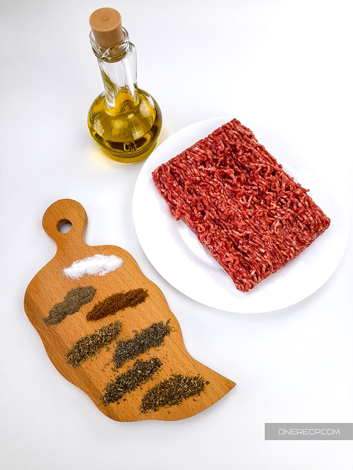 Ingredients and seasonings for ground beef set on a table
