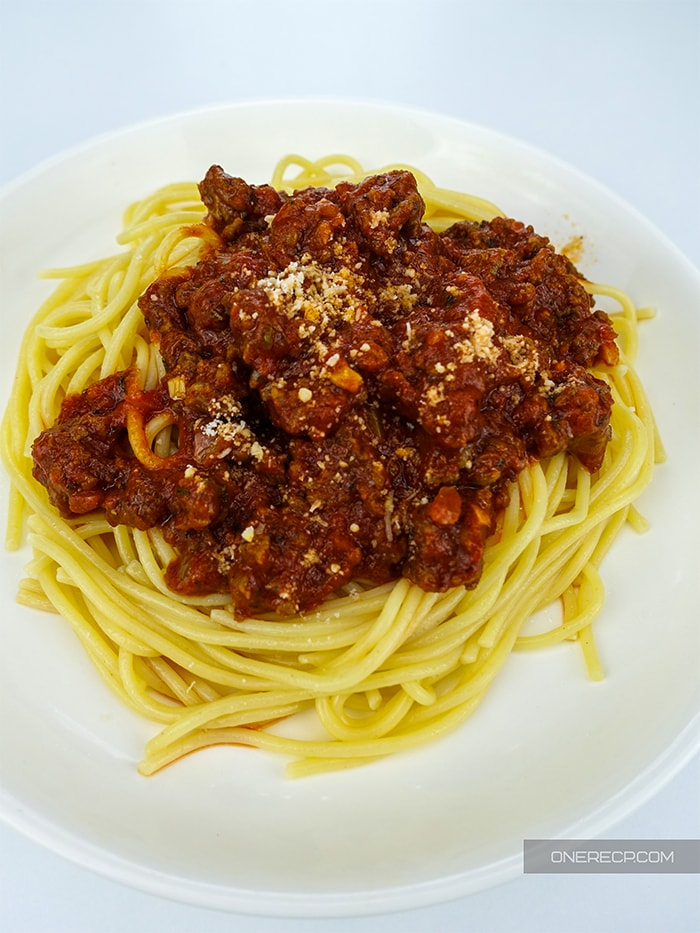 A dish with spaghetti and bolognese sauce on top