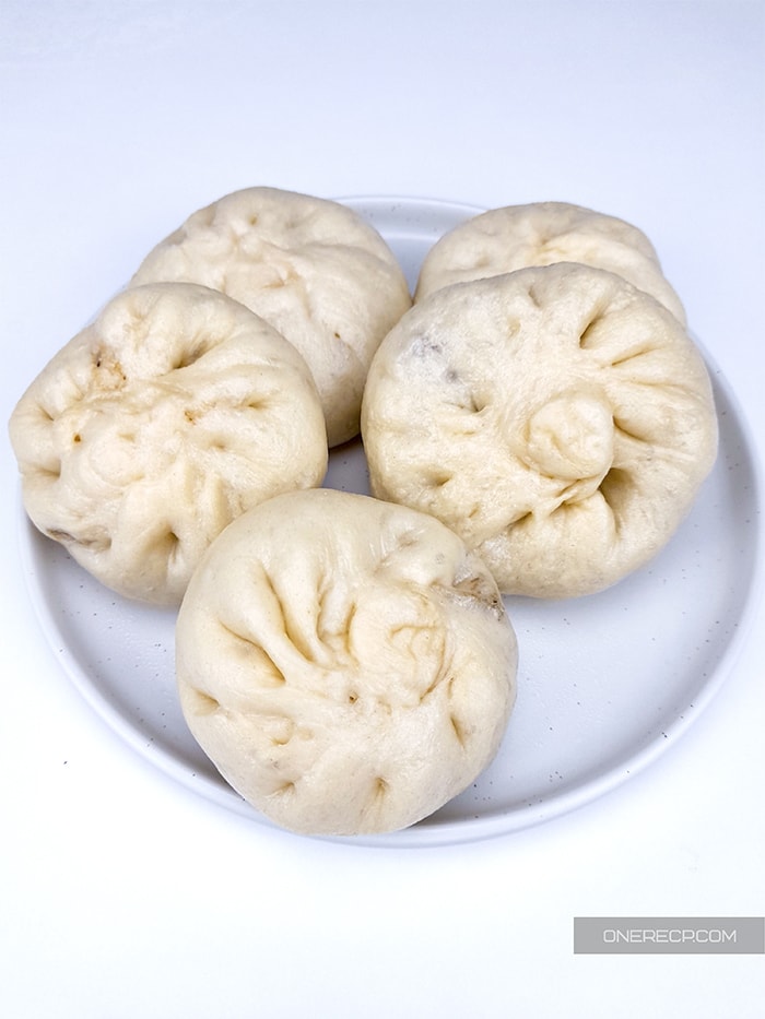 a plate of 5 steamed whole pork buns