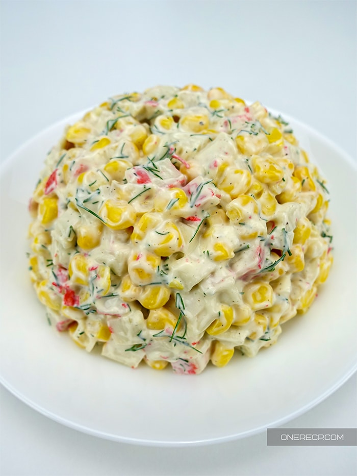A serving of imitation crab meat salad shaped as a ball