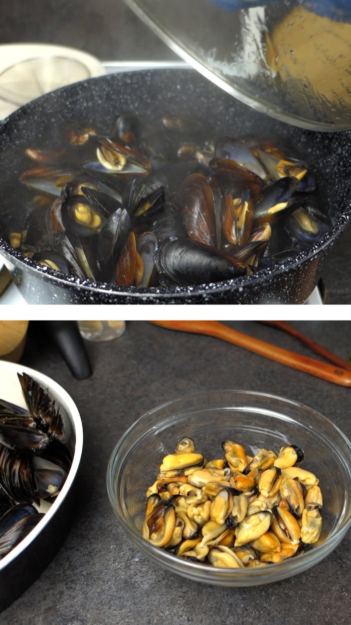 Cooked mussels with open shells in a pot and shelled mussel meat in a bowl