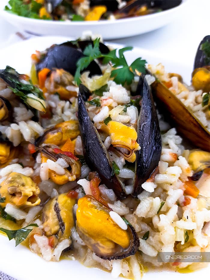Mussels with rice on a plate.