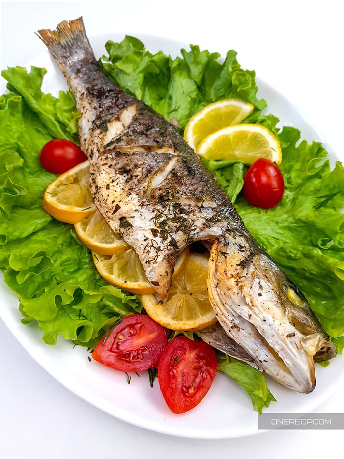 Oven roasted branzino over a bed of lettuce and cherry tomatoes