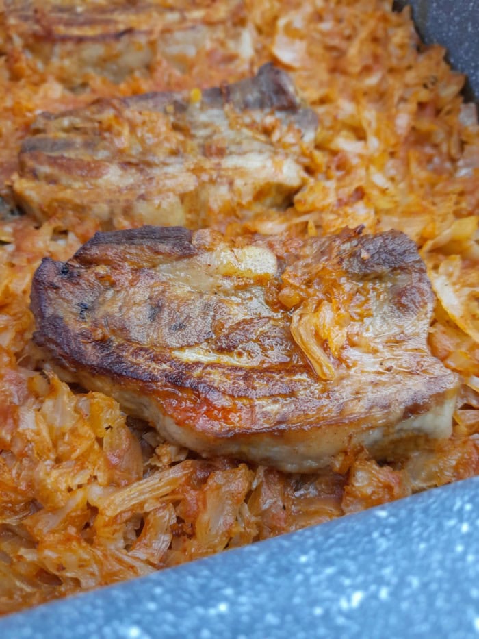 close up of pork and sauwerkraut in a baking tray