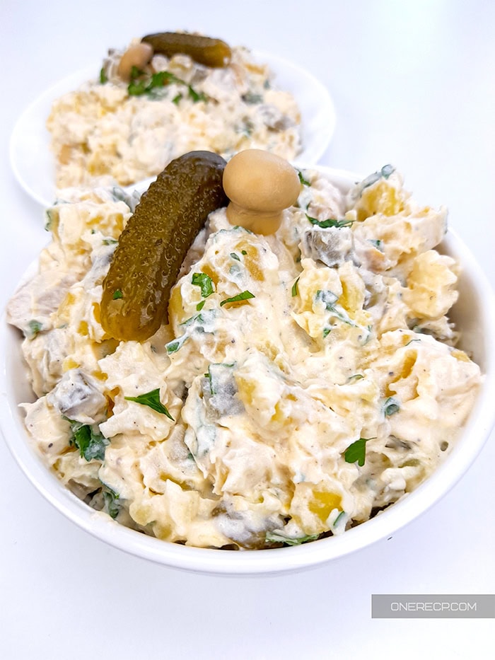 A serving of potato salad with pickles