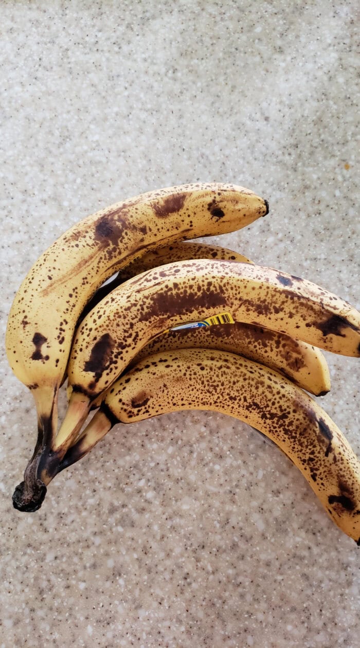 A bunch of ripe bananas with brown spots, perfect for naturally sweetening muffins, breads, and pancakes.