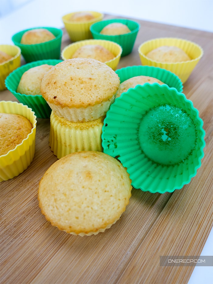 cooling muffins made in silicone molds on a wooden board 