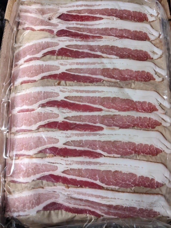 pieces of sliced raw bacon placed next to each other