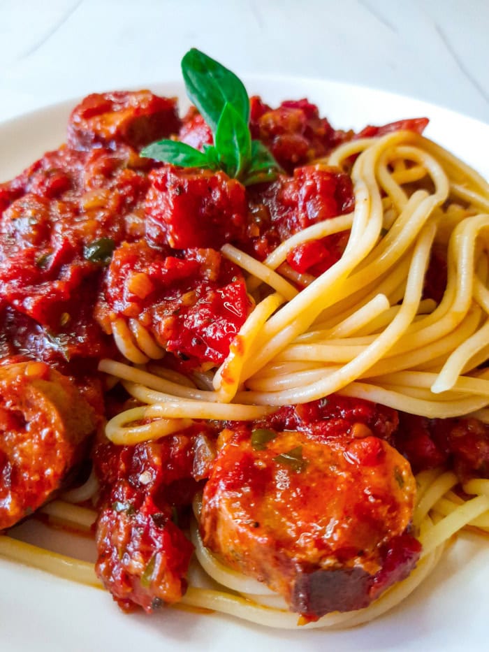 a serving of spaghetti and sauce made from real tomatoes and italian sausage