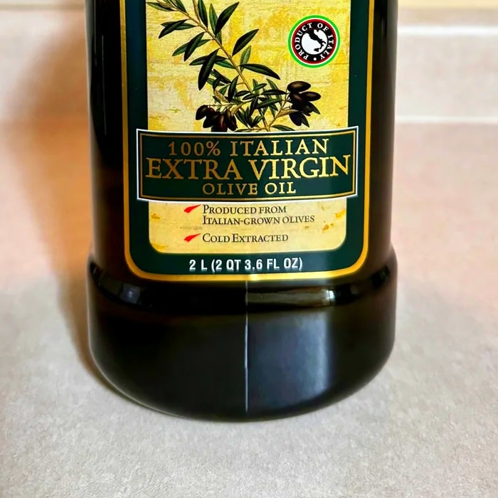 a close up of a bottle of 100% extra cirgin olive oil