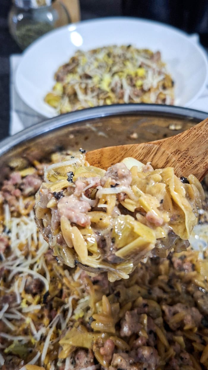 Creamy sweet Italian sausage orzo served in a skillet with leeks and Parmesan