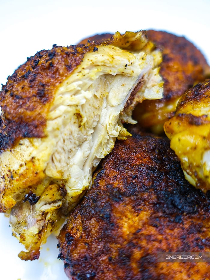 a couple of cooked chicken thighs with one cut so that the inside of the tender meat and its color can be seen