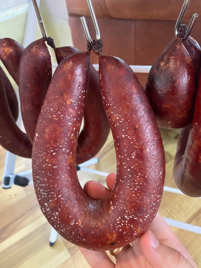 hanged sausage covered in miniature white specks