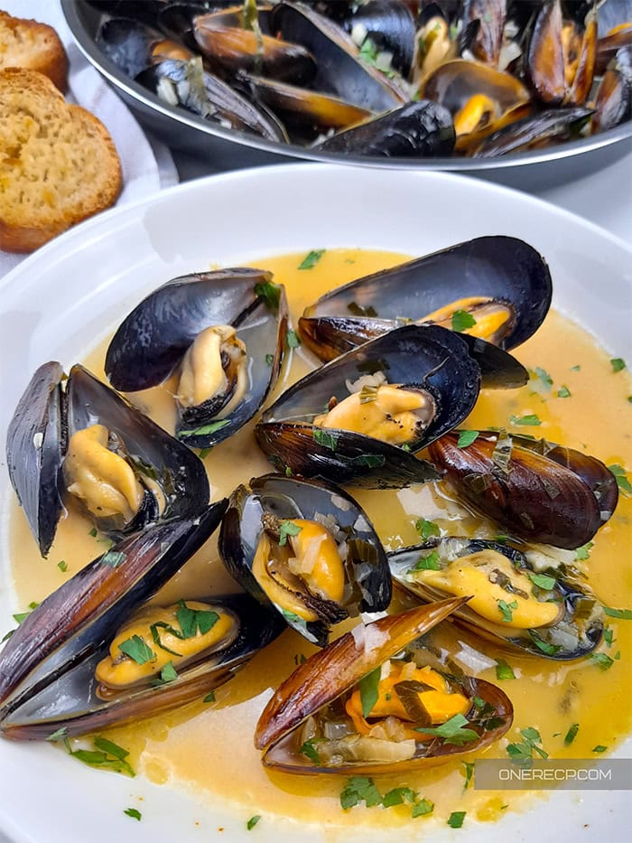 A serving of mussels with white wine garlic butter sauce