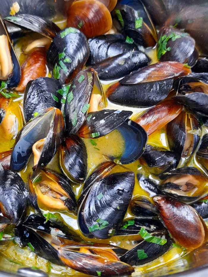 Close-up of white whine garlic butter sauce mussels