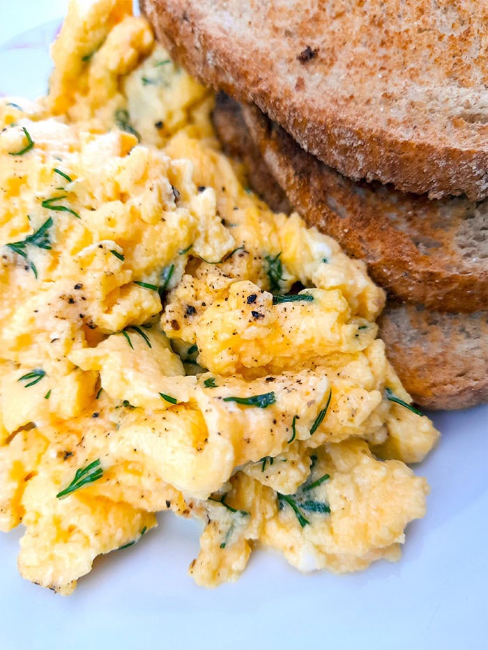 yogurt scrambled eggs with dill next to 3 slices of toast